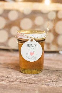 a jar of honey sitting on top of a wooden table