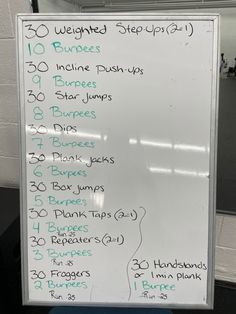 a white board with instructions on how to do squats and triceps in the gym