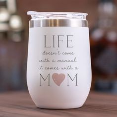 a white wine glass with the words life doesn't come with a manual it comes with a mom