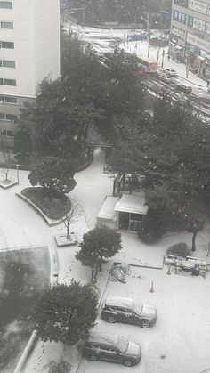 an aerial view of a parking lot in the snow