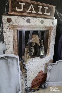 there is a fake ghost in the window with chains hanging from it's sides