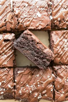 chocolate brownies with frosting and sprinkles cut into squares on a plate