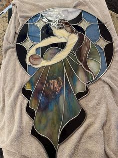 a stained glass plate sitting on top of a table