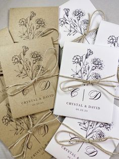 four wedding stationery cards tied together with twine and string, each featuring a bouquet of wildflowers