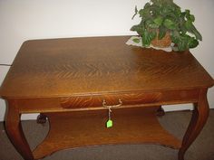 a wooden table with a potted plant sitting on it's top and bottom