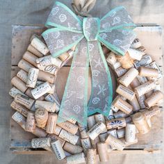 a wreath made out of wine corks with a bow