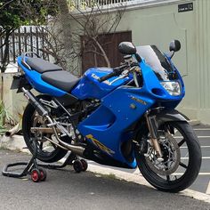 a blue motorcycle is parked on the street