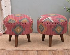 two small stools sitting on top of a rug