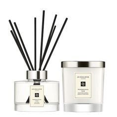 an image of a candle and reeds on a white background with the words joss cologne