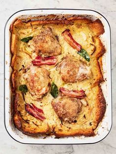 a casserole dish with meat and cheese in it on a marble countertop