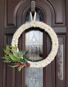 a christmas wreath hanging on the front door