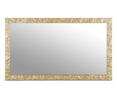 a gold framed mirror sitting on top of a white wall