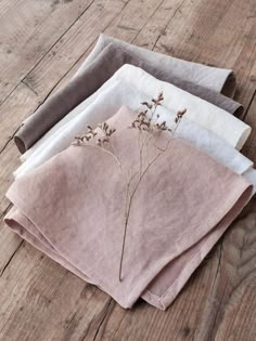 four linen napkins with dried flowers on them