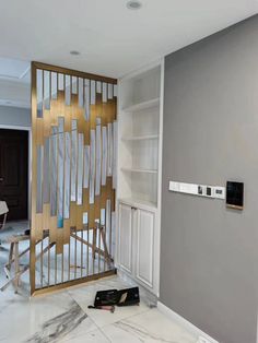 the interior of a house being remodeled with white and gold paint on the walls, doors and shelves