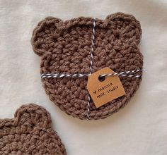 a crocheted teddy bear with a tag attached to it