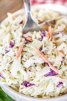 coleslaw in a white bowl with a spoon