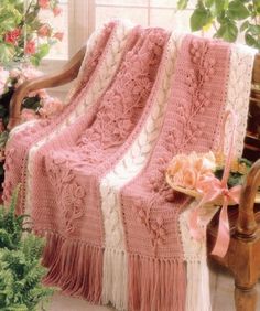 a crocheted blanket is sitting on a chair