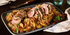 a pan filled with meat and pasta on top of a table