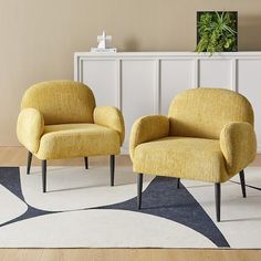 two yellow chairs sitting on top of a white rug