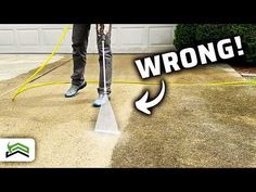 a man is using a vacuum to clean the driveway