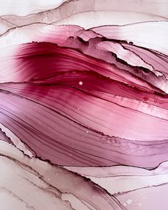 an abstract painting with pink and purple colors on it's surface is shown in close up