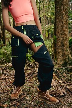 Made for your next hiking trip, these convertible pants feature a high-rise fit and cargo-inspired pockets with cinched bottom hems. **Fit:** High-rise, slouchy, relaxed fit, ankle-length **Features:** Durable, water-resistant fabrication; convertible design that zips off and turns into shorts, stretchy elastic waistband, zip-fly and button closure, belt loops at waistband, zippered pockets at legs, pockets with snap-button closures, contrast trim **Why We | Morning Meadow Hike Pants by FP Movem Convertible Pants, Free People Movement, Fp Movement, Free People Black, Hiking Trip, Contrast Trim, Boho Outfits, Highlighter, Snap Button