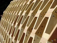 a wooden structure made out of wood planks with holes in the center and sides