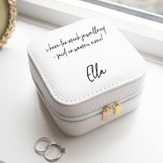 a small white box sitting on top of a table next to a keychain