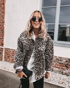 a woman in leopard print jacket and sunglasses