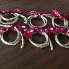 several pieces of rope tied together on a wooden table with red and white numbers painted on them