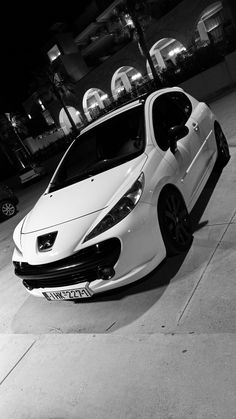 a white car parked in front of a building