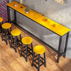 four yellow stools sit in front of a counter