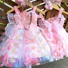 Dress up your little one like a magical fairy with the Tania Fairy Tulle Dress! Made with a lightweight tulle and smocked design, these exquisite fluffy dresses come with fairy wings to make your gal look truly enchanting. Those on the hunt for a magical outfit need look no further! * Wings are lightweight, flexible, soft, and attached. They cannot be removed. * Detached tutu underneath to add volume. Can be worn separately. * The loose fitting style allows some wiggle room on exact sizing. *Exa Spring Fairy Dress With Ruffles For First Birthday, Pink Fairy Style Tutu Dress With Ruffles, First Cake Smash, Pink Fairy Tutu Dress For Birthday, Second Birthday Girl, Fluffy Dresses, Playful Pink Ruffled Fairy Dress, Butterfly Baby Dress Fairy Wings, Princess Costume