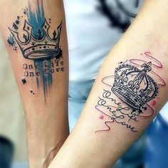 two people with tattoos on their arms holding each other's hands and one has a crown