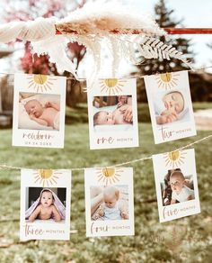 a baby's first year photo hanging on a clothes line with photos and feathers