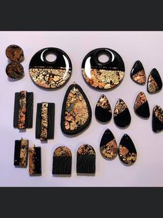 an assortment of black and gold jewelry pieces