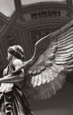 an angel statue is shown in black and white