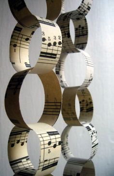 several rolls of sheet music paper are arranged in the shape of rings with musical notes on them