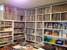 a room filled with lots of different types of records and cds on shelving units