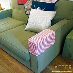 a green couch with several pillows on it