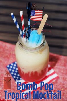 a drink with straws and toothpicks in it sitting on a red table cloth