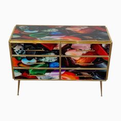 a multicolored chest of drawers with glass doors