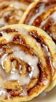 cinnamon rolls with icing on a white plate