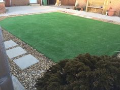 an artificial grass lawn in a back yard