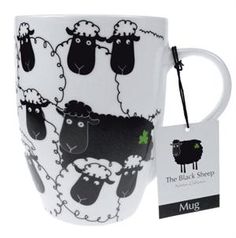 the mug has sheep on it and is next to a tag