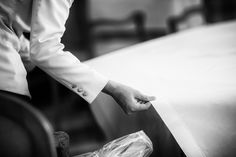 a person in a suit and tie sitting at a table with a piece of paper