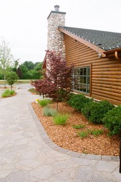 a wooden house with a stone walkway leading to it