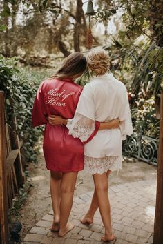 two women in robes walking down a path