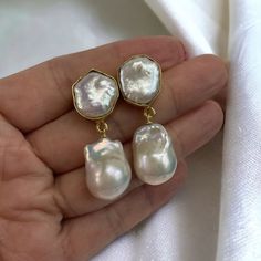 This large baroque earring is gorgeous! Perfect for weddings, or as a bridesmaids gift! It is truly a statement pearl earrings! Simply stunning! The actual pair on the listing has been sold. This is custom ordered.  The Baroque or flameball cultured freshwater dangling pearls are large 14mm to 15mm x 20mm to 21mm,  white, lustrous, AAA quality, attached to a gold filled bail/peg.  The ear finding is a beautiful 22k gold plated freshwater baroque Pearl, bezeled, brass body. Comes with large ear n Formal Baroque Pearl Earrings, Pearl White Baroque Wedding Earrings, Elegant White Baroque Pearl Earrings, Elegant Pearl White Baroque Earrings, Luxury Baroque Pearl Earrings In Pearl White, Statement Pearl Earrings, Pear-shaped Baroque Pearl Earrings For Weddings, Pearl Gold Earrings, Double Pearl Earrings