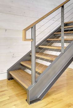 a metal and wood stair case in a room